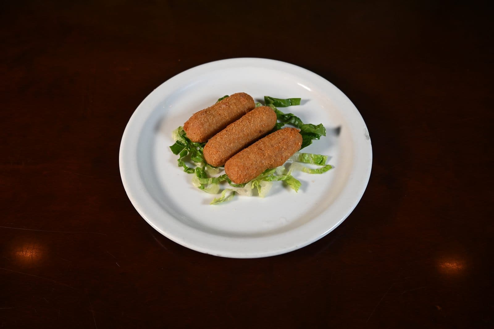 Ham croquetas served over greens