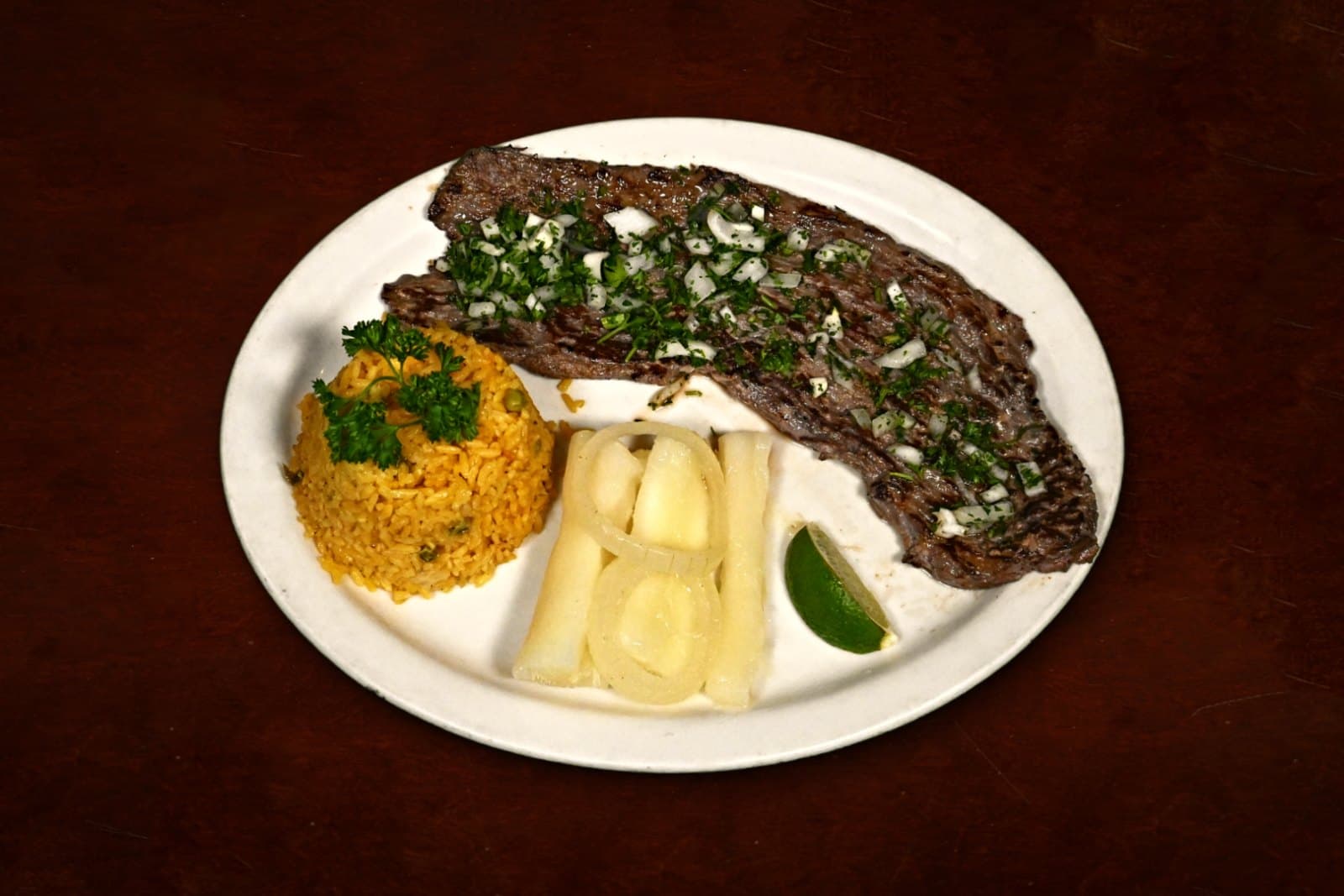 Bistec de palomilla: grilled thin-cut steak with yellow rice and yuca