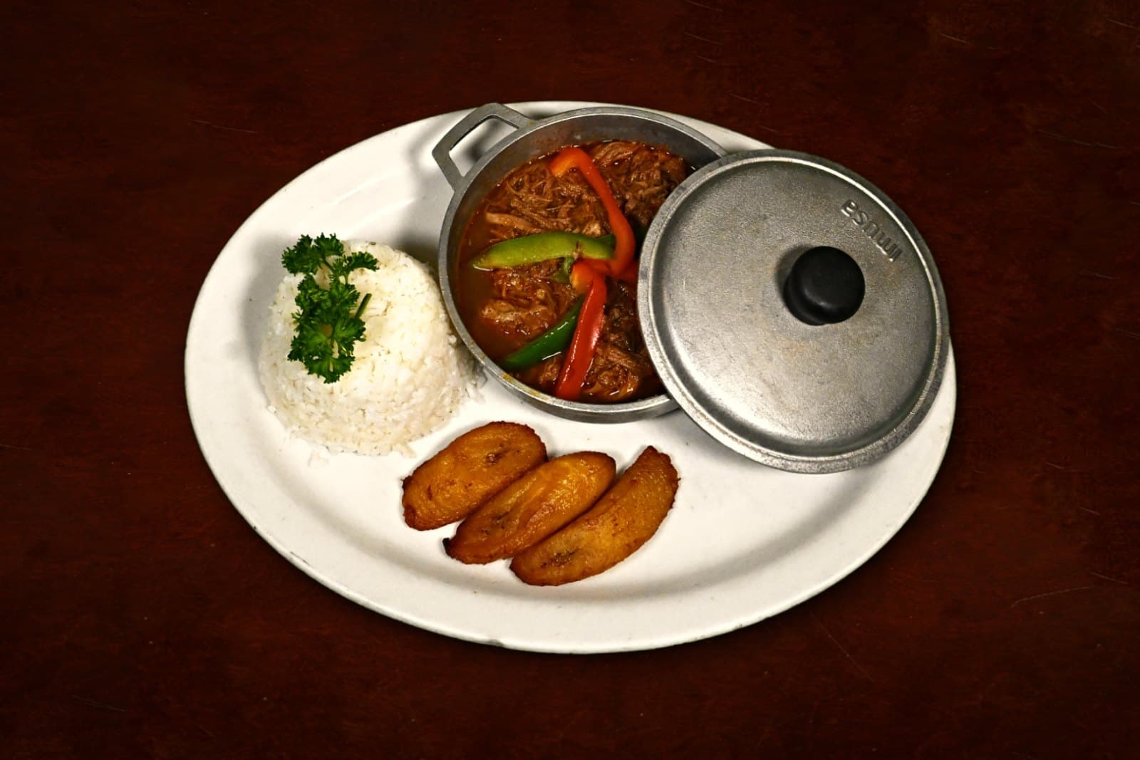 Ropa vieja slow-roasted in creole sauce with white rice and maduros